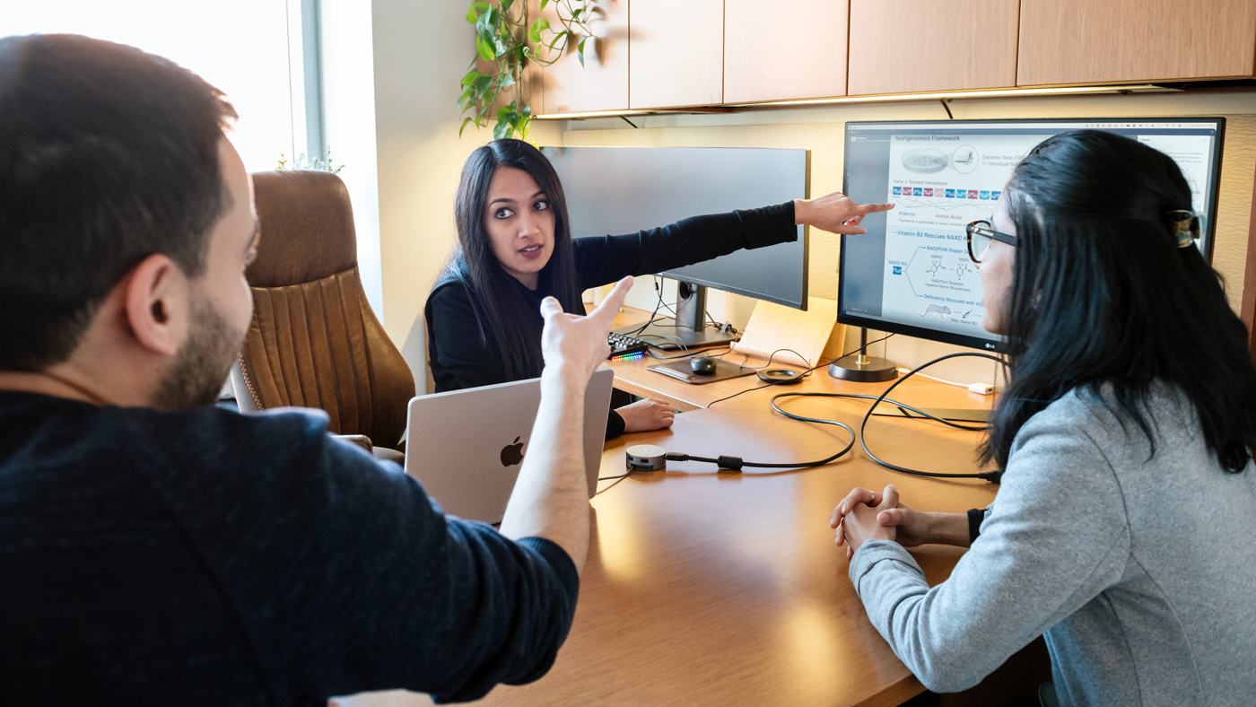 Isha Jain in her office at Gladstone Institutes with Skyler Blume and Ankur Garg