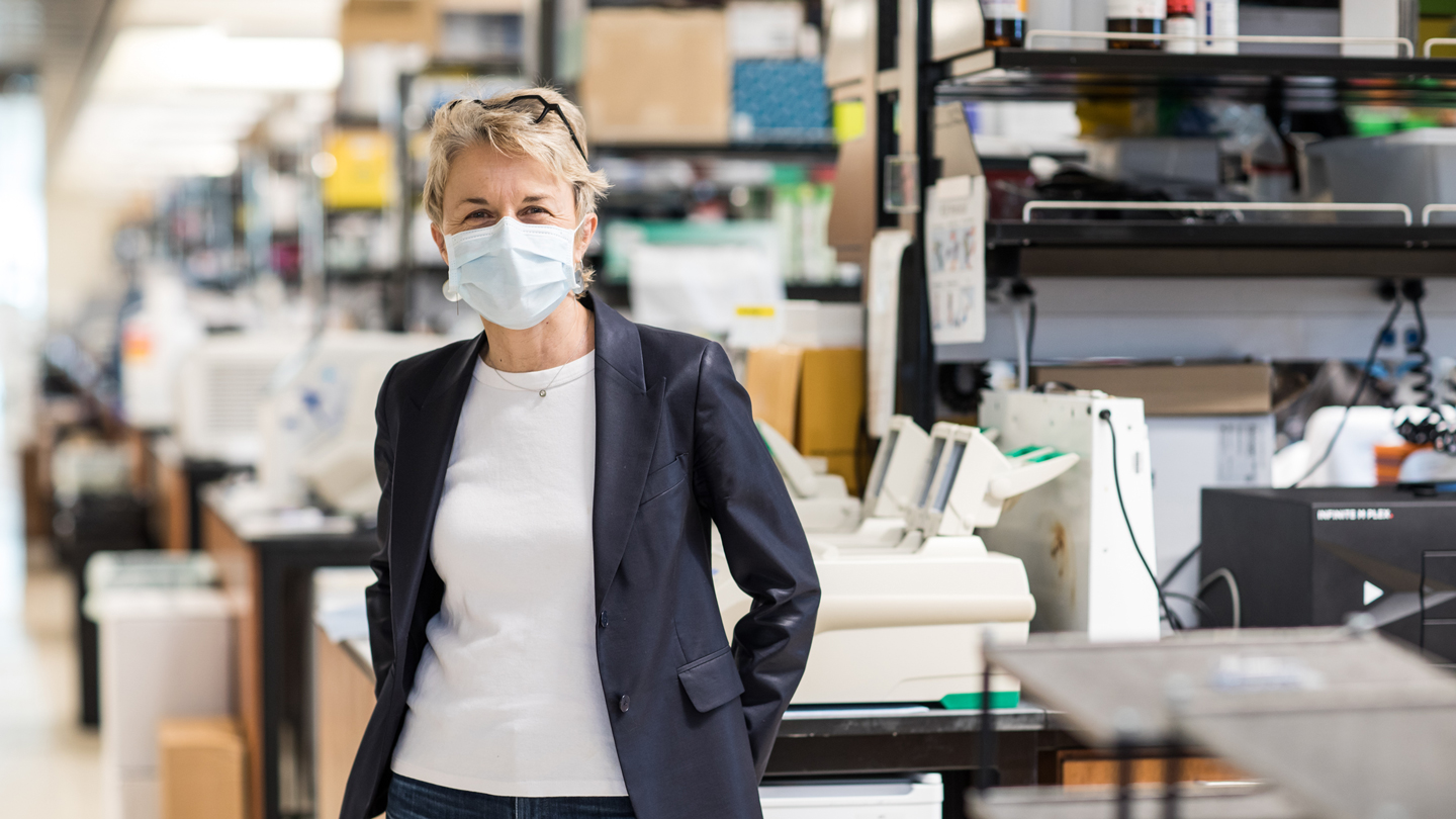 Headshot of Melanie Ott in the lab wearing a mask