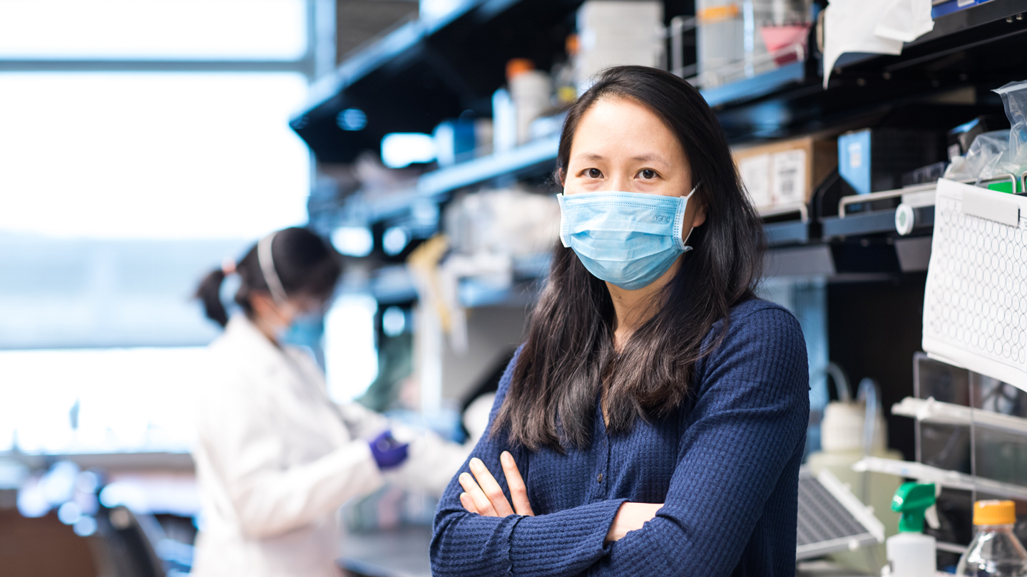 Nadia Roan, wearing a face mask, while in the lab