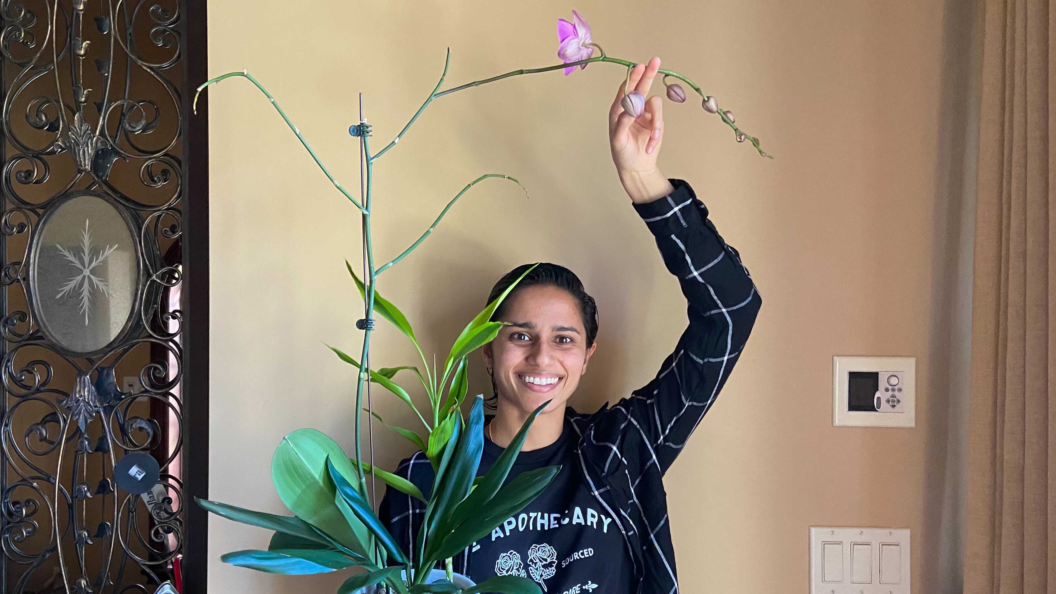 Antara Rao holding her orchid above her head