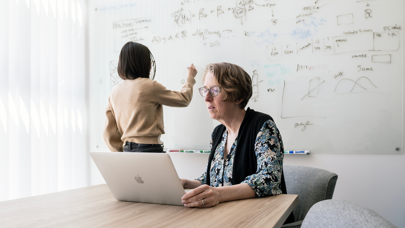 Katie Pollard working in a conference room at Gladstone Institutes