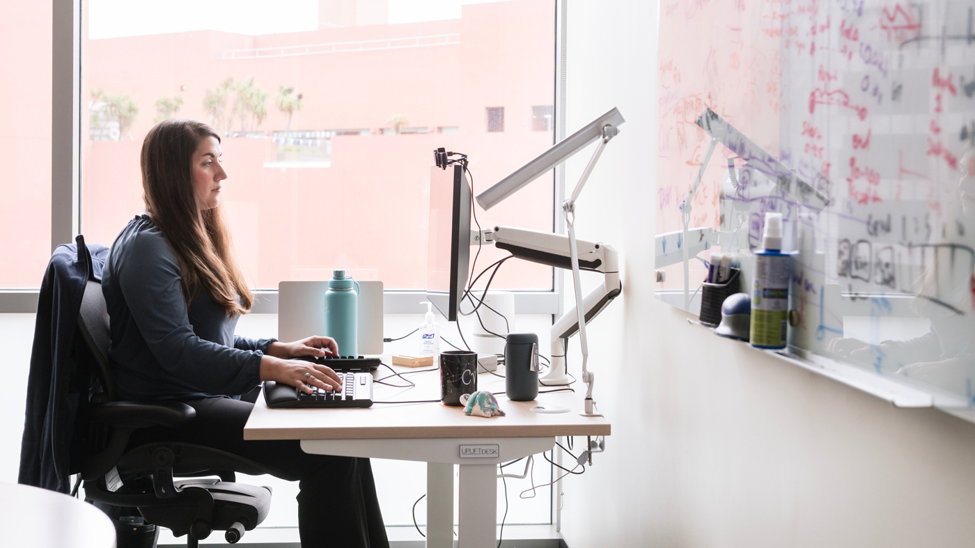 Christina Theodoris working at her computer at Gladstone Institutes. 