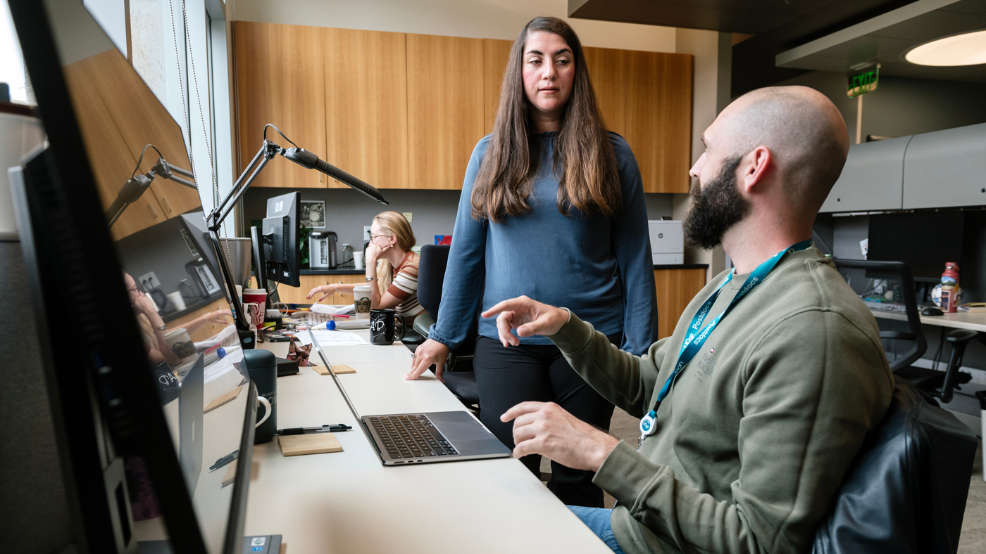 Gladstone investigator Christina Theodoris speaks with fellow scientist