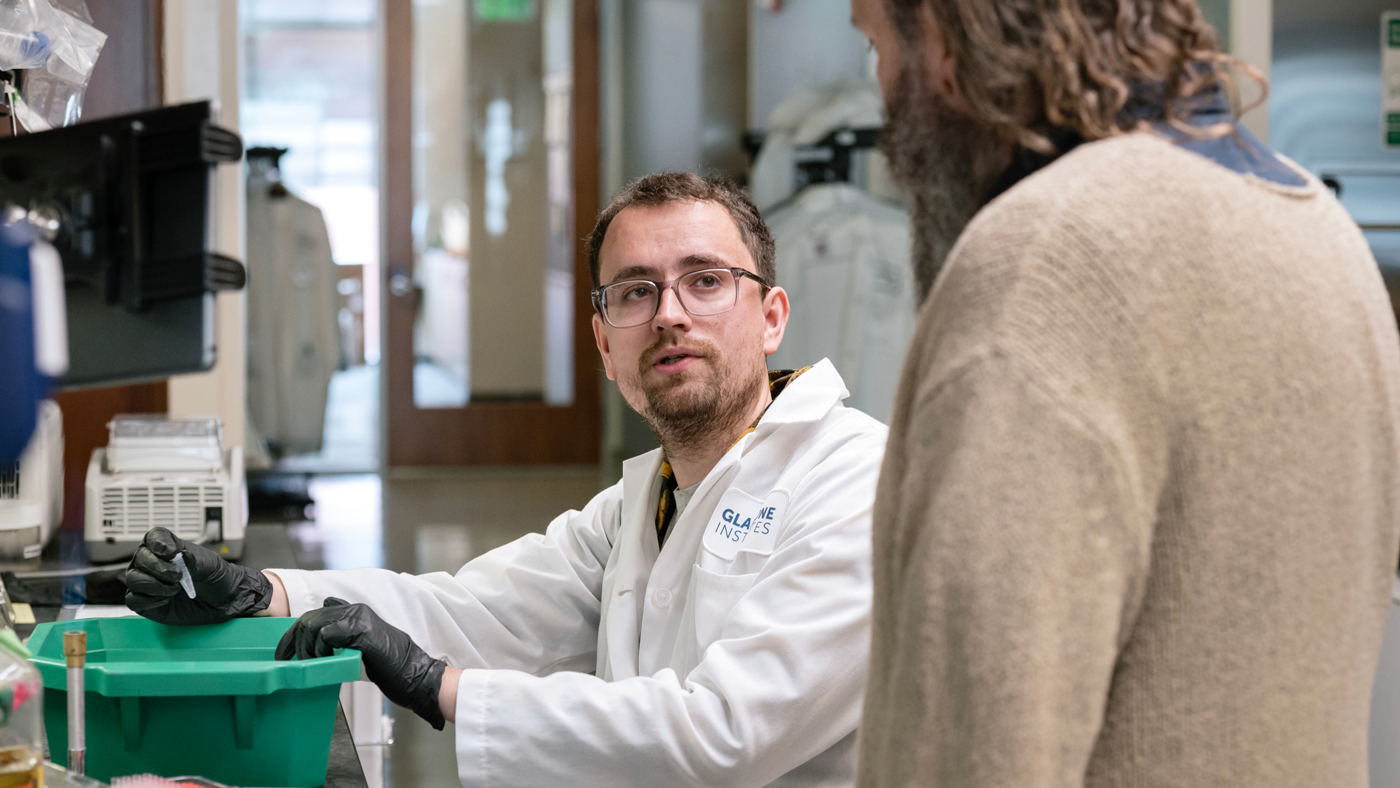 Alejandro González-Delgado speaking with Seth Shipman in the lab at Gladstone Institutes
