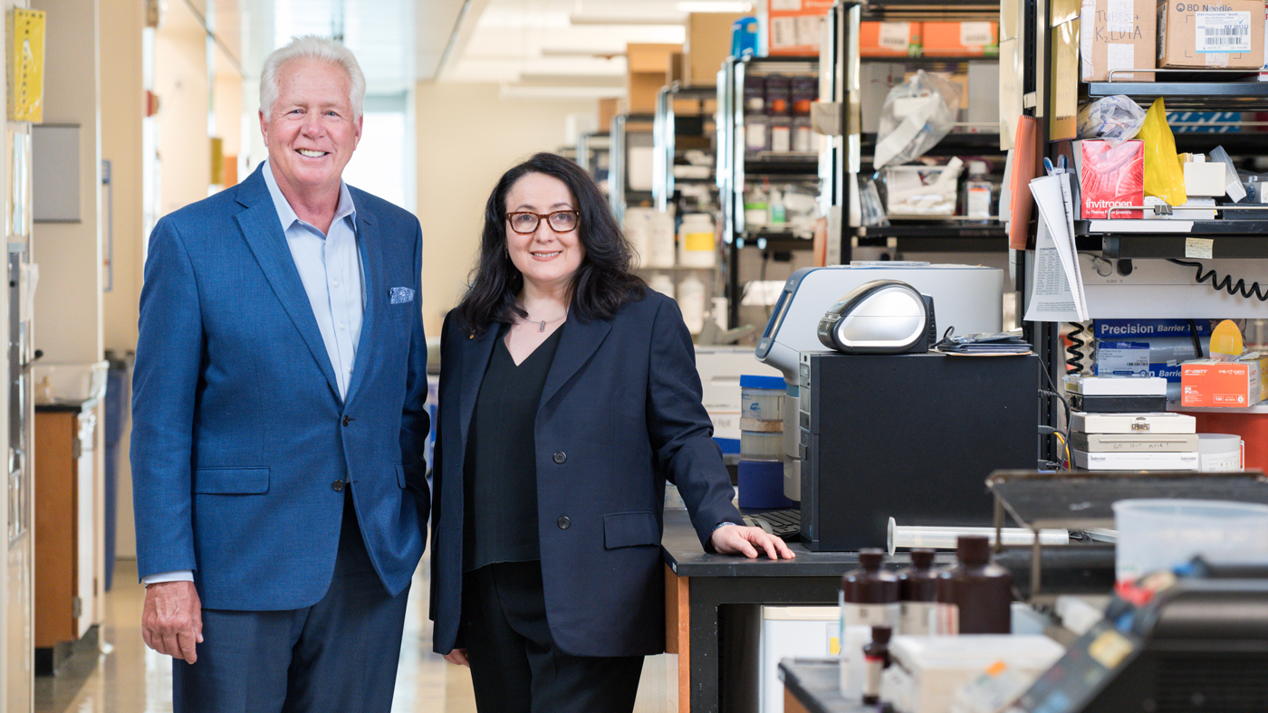 Warner Greene and Katerina Akassoglou smiling in the lab at Gladstone Institutes