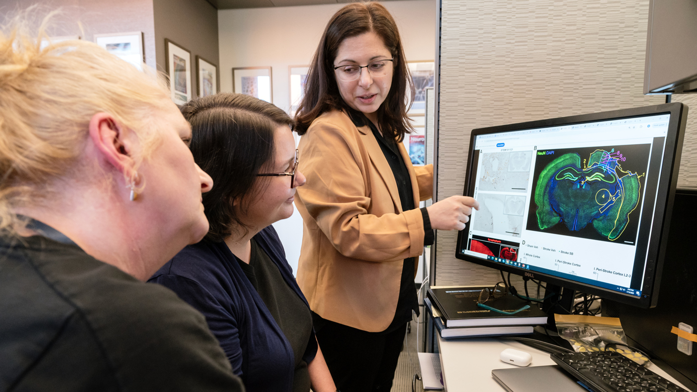 Jeanne Paz and her collaborators, in an office at Gladstone Institutes