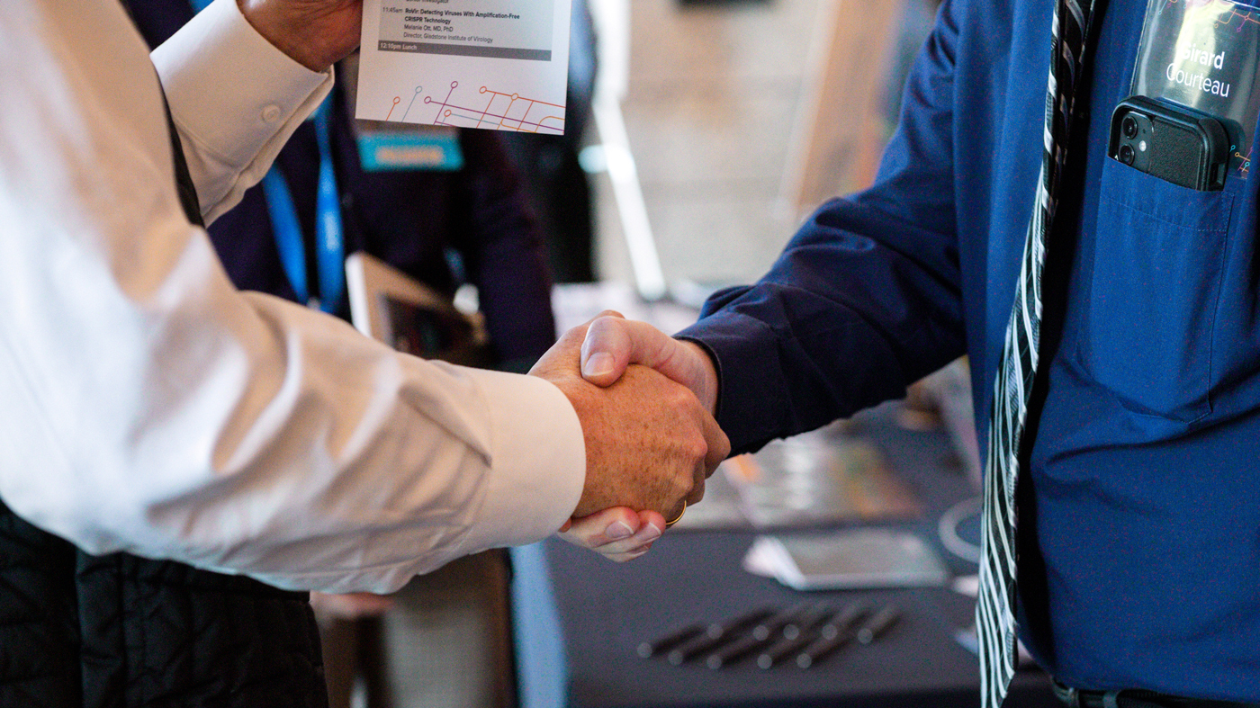 two business people dressed in ties shake hands