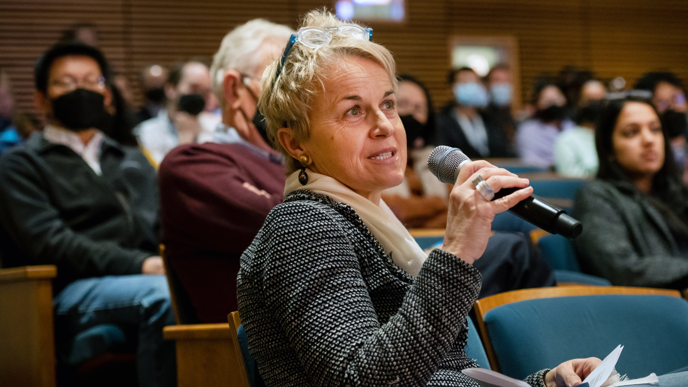 Melanie Ott speaking in the auditorium at Gladstone Institutes