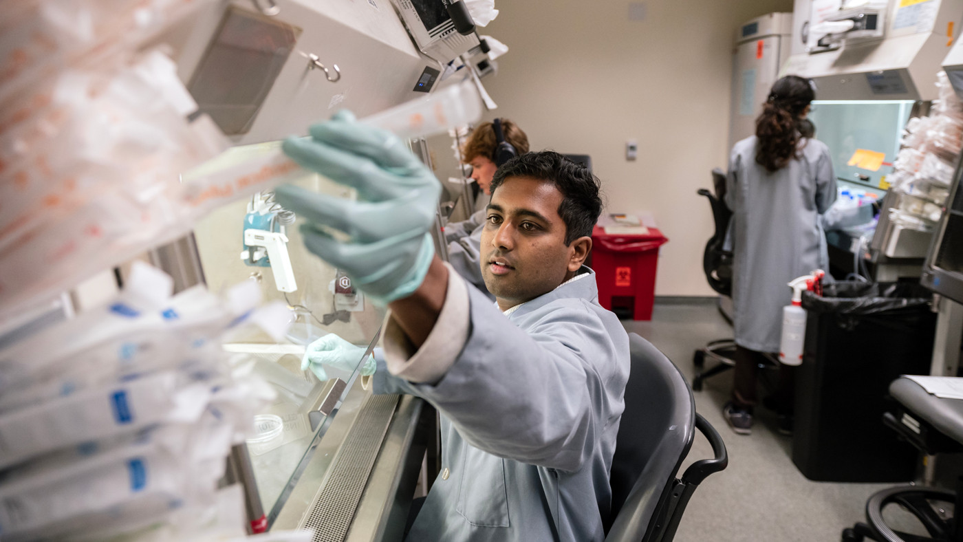 Gokul Ramadoss working at a lab bench at Gladstone Institutes
