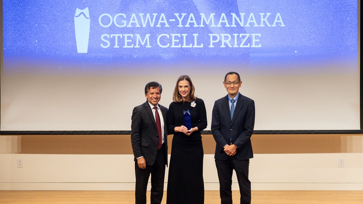 Gladstone President Deepak Srivastava (left), prize winner Magdalena Zernicka-Goetz (center), and Gladstone Senior Investigator and Nobel Laureate Shinya Yamanaka (right) share a moment on stage after Zernicka-Goetz received the award on November 16, 2023.
