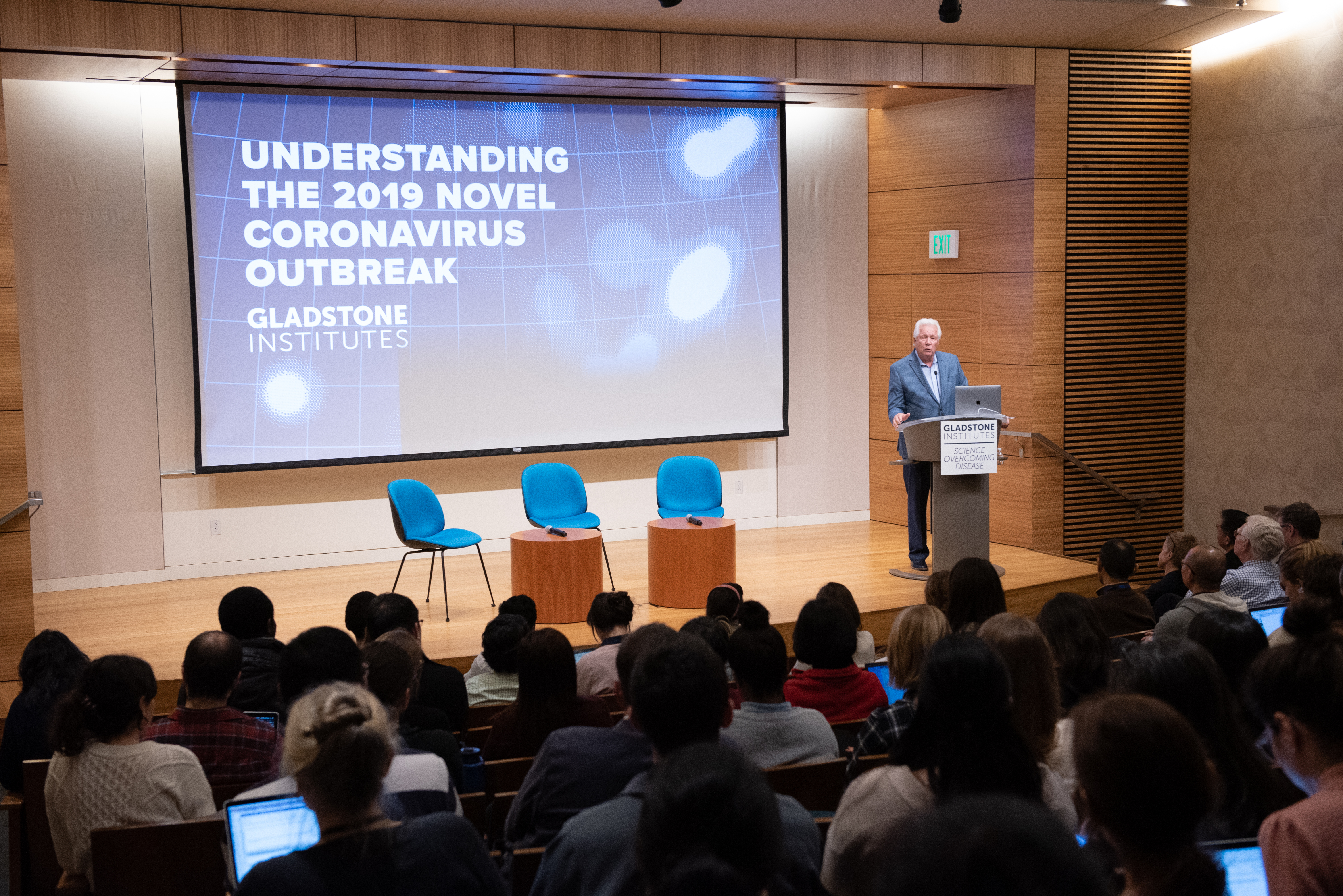 Warner Greene standing at a podium speaking during the Understanding the Coronavirus event